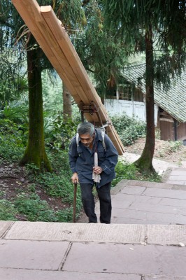 Rather old and small people carry amazingly heavy loads up the mountain