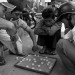 Typical scene in Vietnam: Vietnamese men crouching over a game of Chinese checkers. Some wearing helmets. :-)