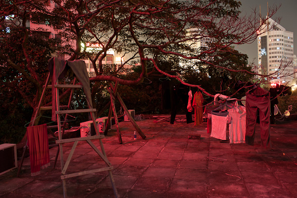 Roof top of the Lotusland hostel in the light of iluminated advertising