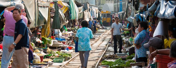 6 times a day the train passes through the Maeklong railway market